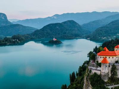 Free Breathtaking aerial view of Bled Castle overlooking Lake Bled in Slovenia surrounded by mountains. Stock Photo