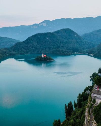 Free Breathtaking aerial view of Bled Castle overlooking Lake Bled in Slovenia surrounded by mountains. Stock Photo